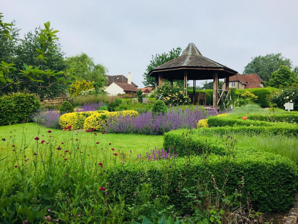 a garden with a gazebo and flowers at Garden Annex in Falfield