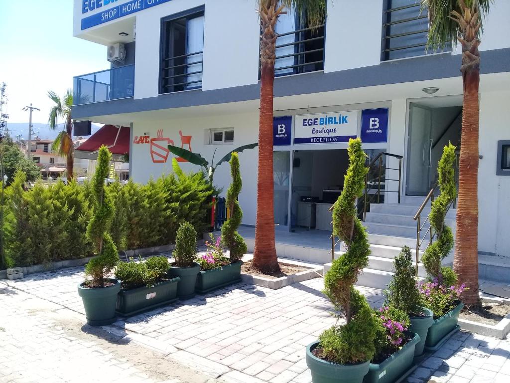 a building with potted plants in front of it at Ege Birlik Boutique in Aydın