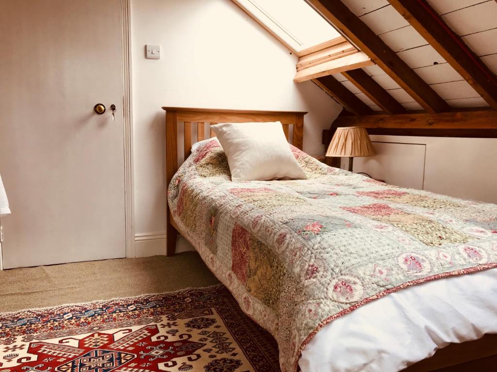 A bed or beds in a room at Tresillian House