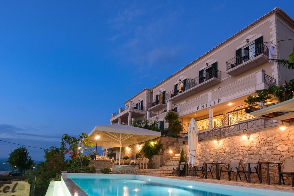 a hotel with a swimming pool in front of a building at Hotel Philip in Pylos