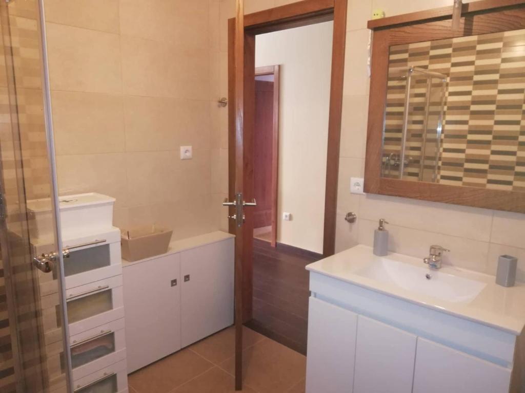 a bathroom with a sink and a mirror at Casa do Terreiro in Macedo de Cavaleiros