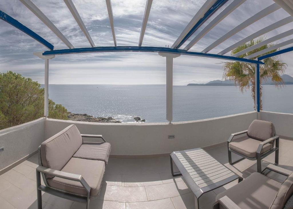a balcony with chairs and a view of the ocean at Villa Dimos in Gythio