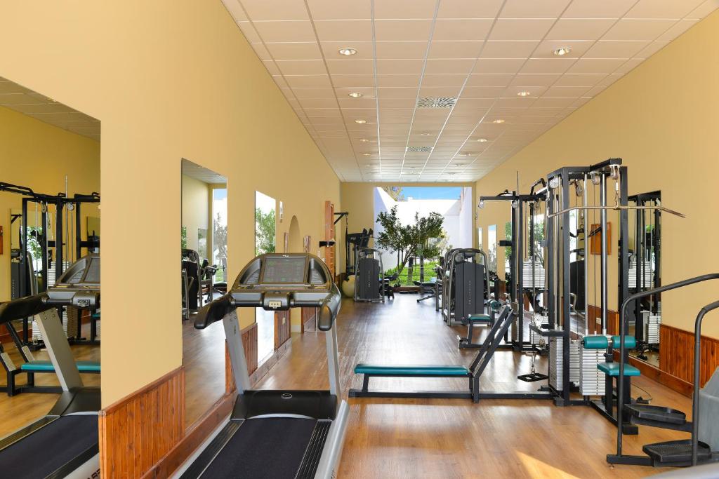 a gym with many treadmills and machines at Hotel Fuerte Conil-Resort in Conil de la Frontera