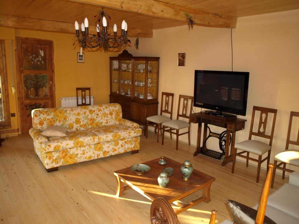 a living room with a couch and a tv at El Peralón de León in  La Aldea de la Valdoncina