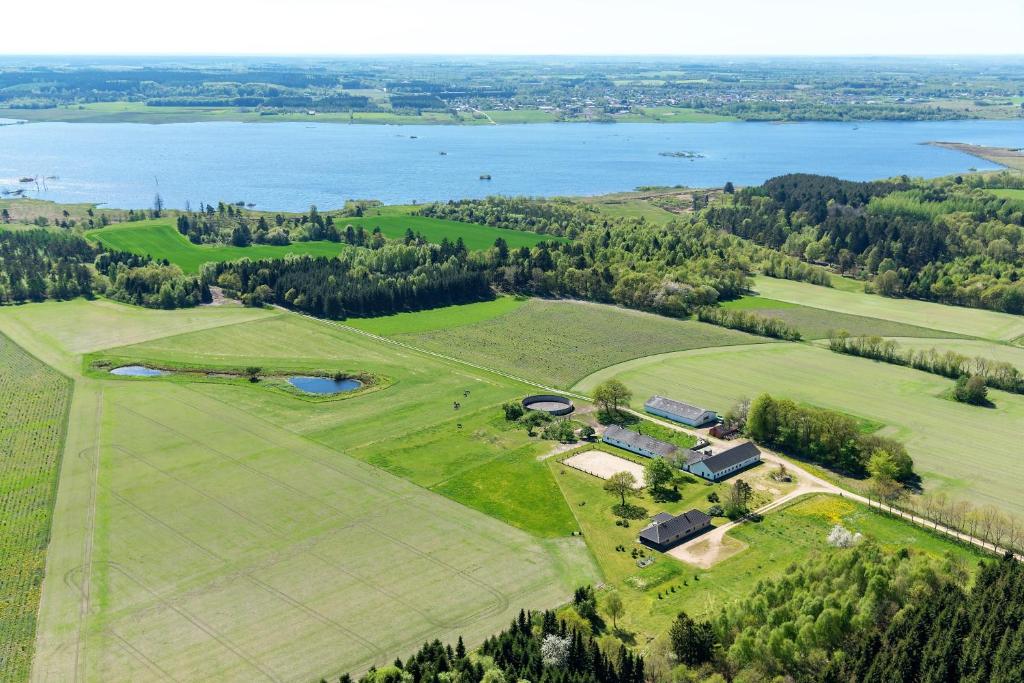 uma vista aérea de um grande campo com um lago em Refshalegaard em Engesvang