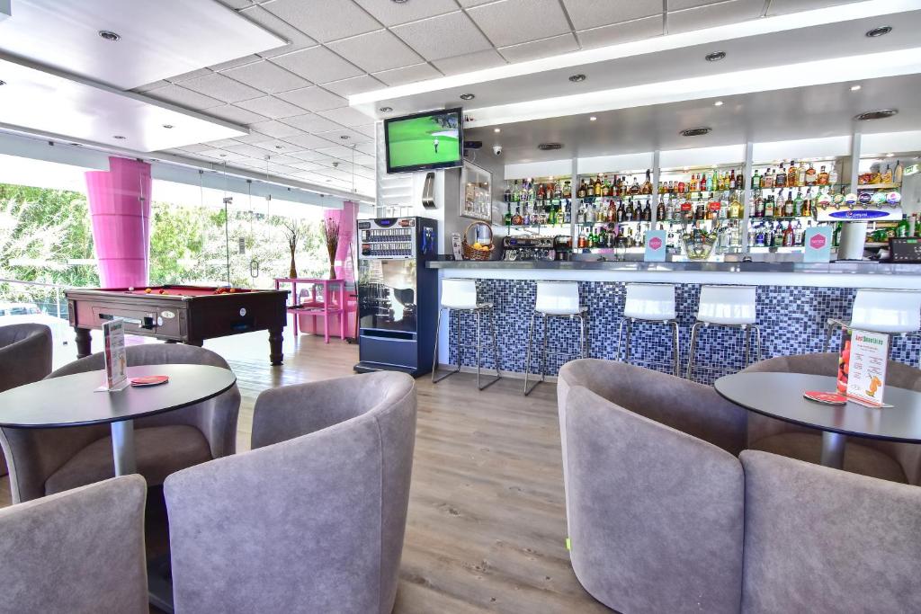 a restaurant with two tables and a bar with a pool table at Bayside Salgados in Albufeira