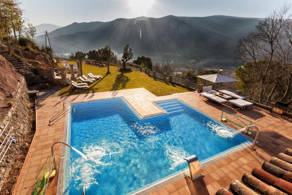 a swimming pool with a view of a mountain at Mas Can Xera in Amer