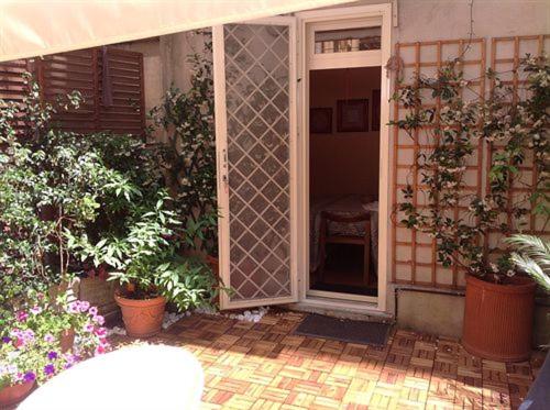 an open door to a patio with plants and flowers at Simonetta Ai Musei Vaticani in Rome