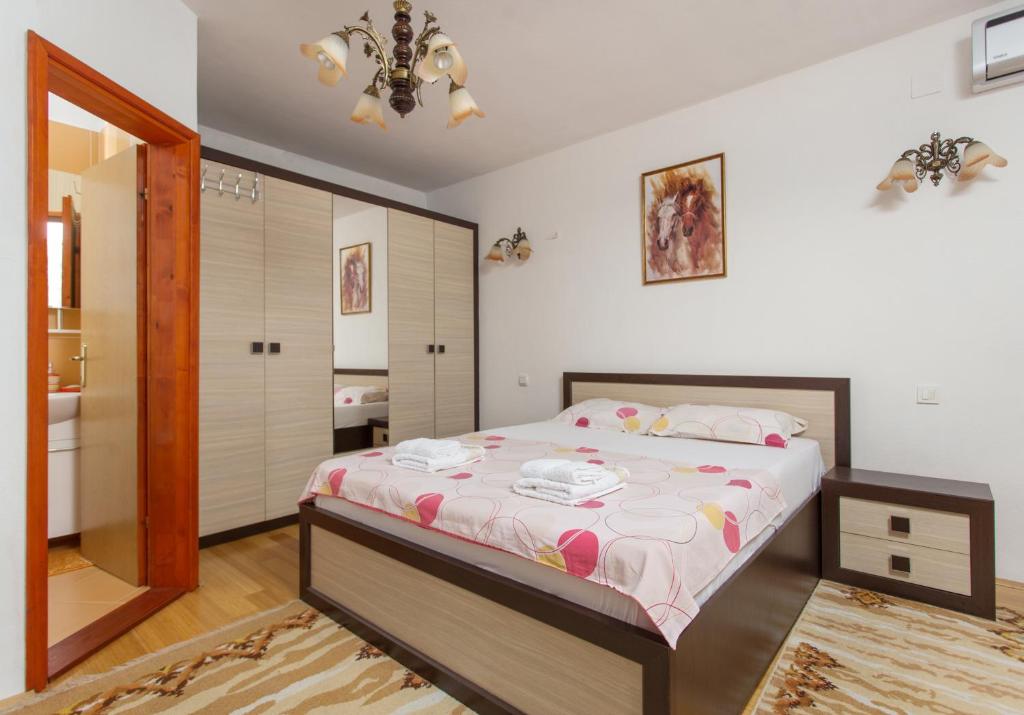 a bedroom with a bed and a bathroom at Apartment Panorama in Kotor
