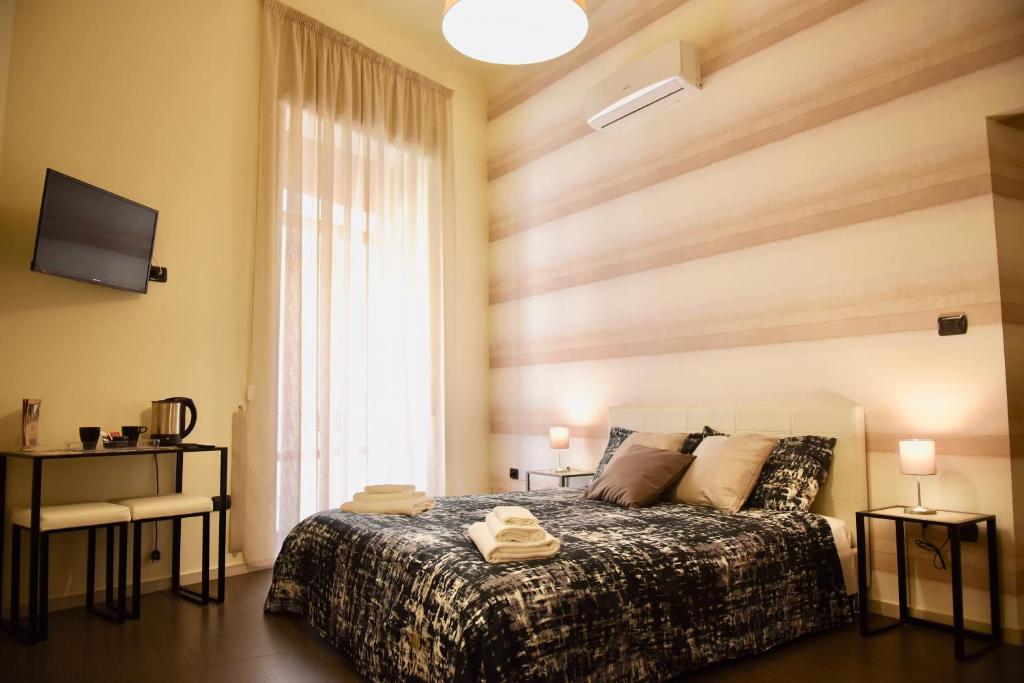 a bedroom with a bed and a large window at Il Duomo Salerno in Salerno