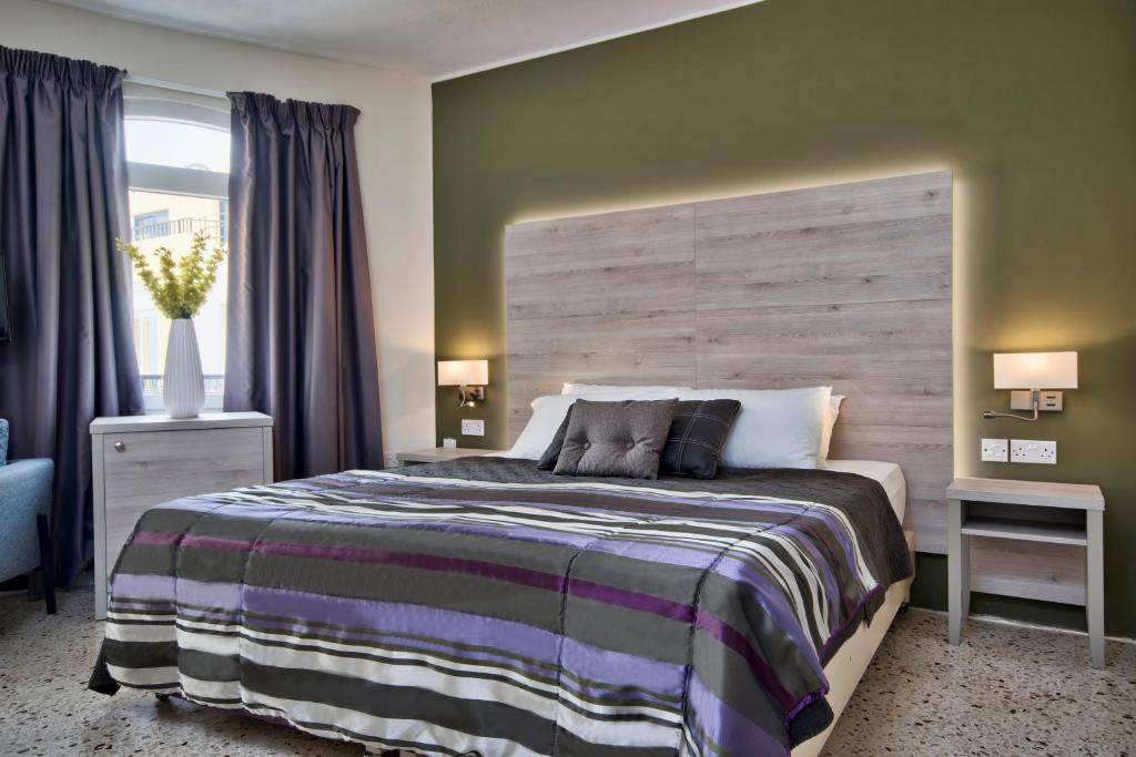 Postel nebo postele na pokoji v ubytování Il Palazzin Hotel