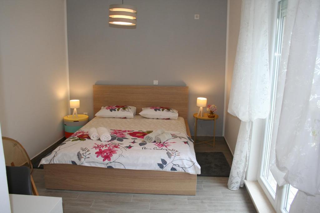 a bedroom with a bed with flowers on it at Room with garden in Split