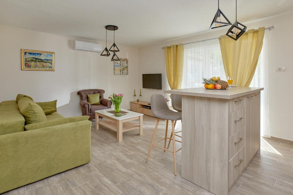 a kitchen and living room with a couch and a table at Apartments Passage in Kotor