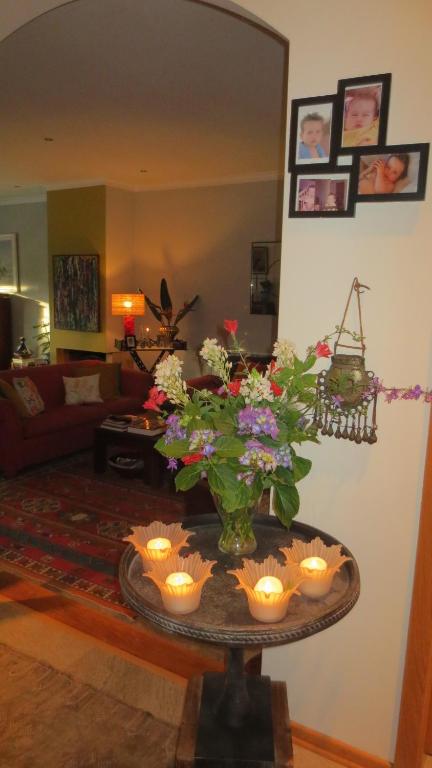 a living room with a table with candles and flowers at A Casa do Lagar in Azeitao