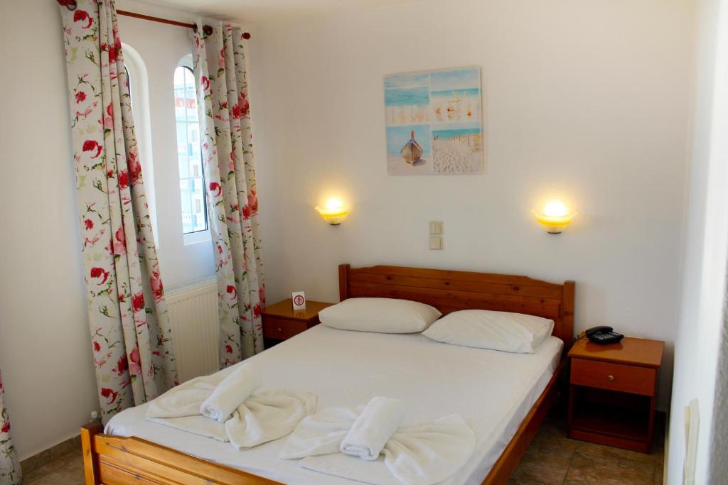 Postel nebo postele na pokoji v ubytování Adriani Inn