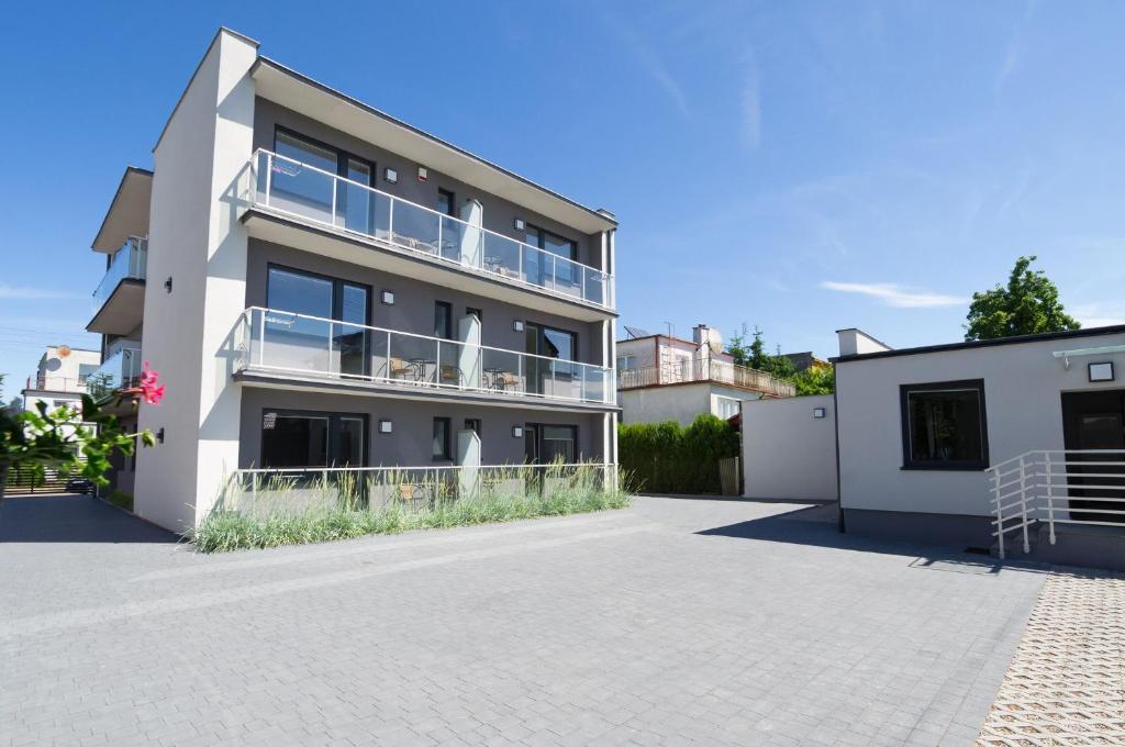 a large white building with a balcony on it at Villa Baltica II in Rewa