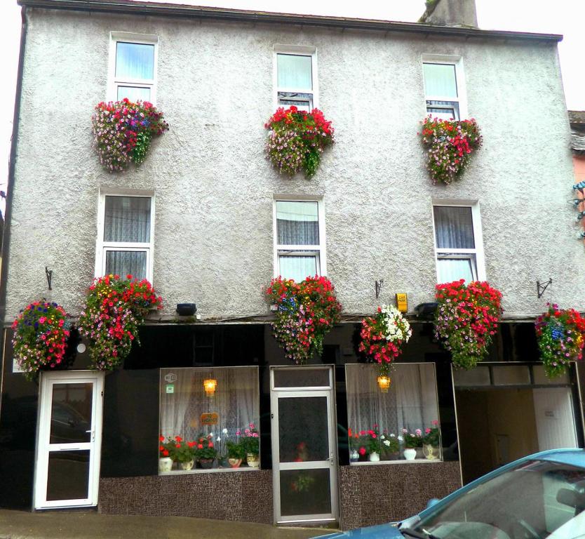 a building with flower boxes on the front of it at Inishross House in New Ross