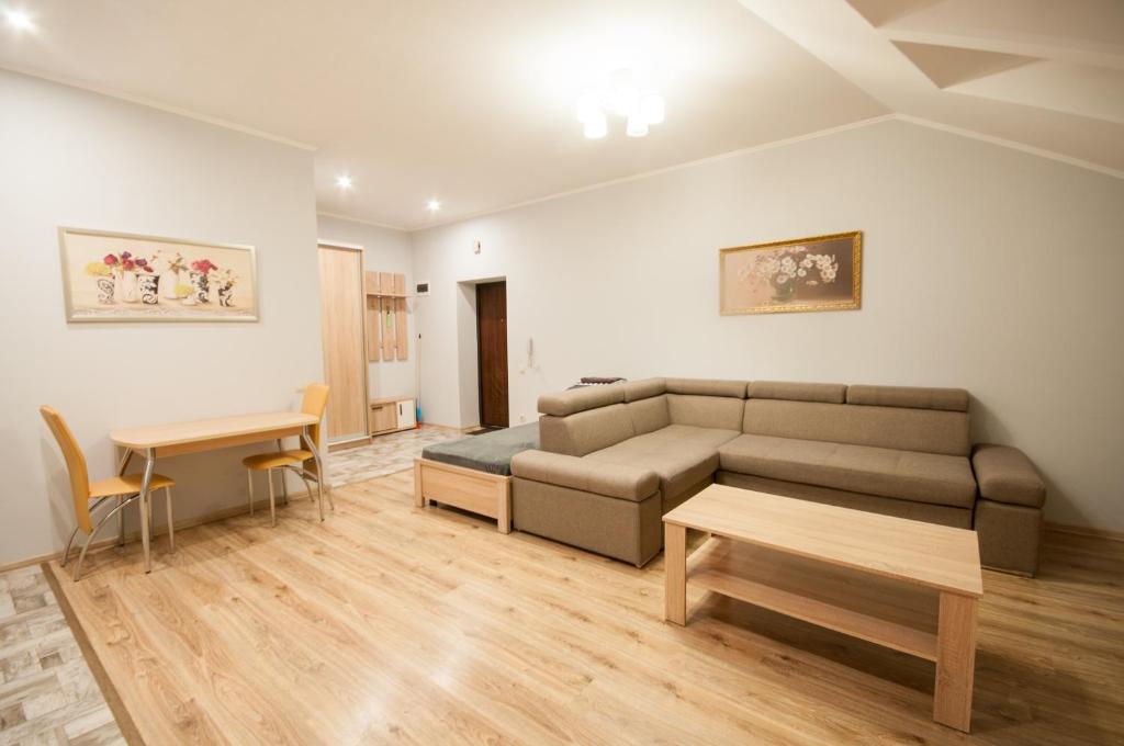 a living room with a couch and a table at Wonderful flat on city center (Mukachivska 4/15) in Uzhhorod