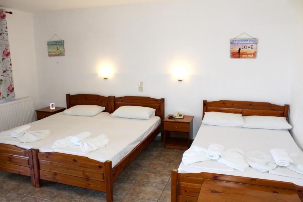 Postel nebo postele na pokoji v ubytování Adriani Inn