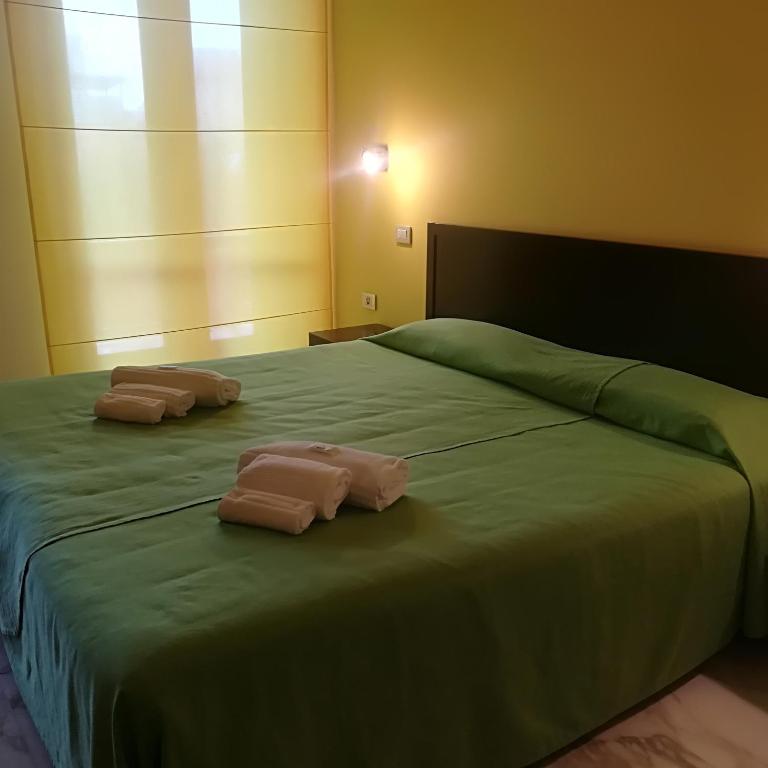 Łóżko lub łóżka w pokoju w obiekcie Hotel I Colori