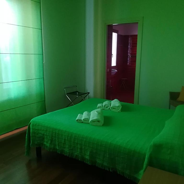 Łóżko lub łóżka w pokoju w obiekcie Hotel I Colori