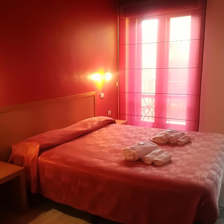 Łóżko lub łóżka w pokoju w obiekcie Hotel I Colori