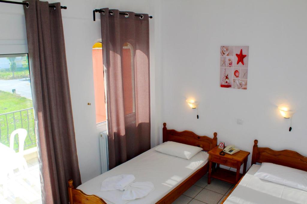 Postel nebo postele na pokoji v ubytování Adriani Inn