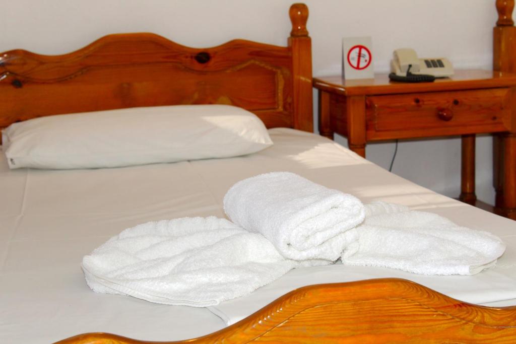 Postel nebo postele na pokoji v ubytování Adriani Inn