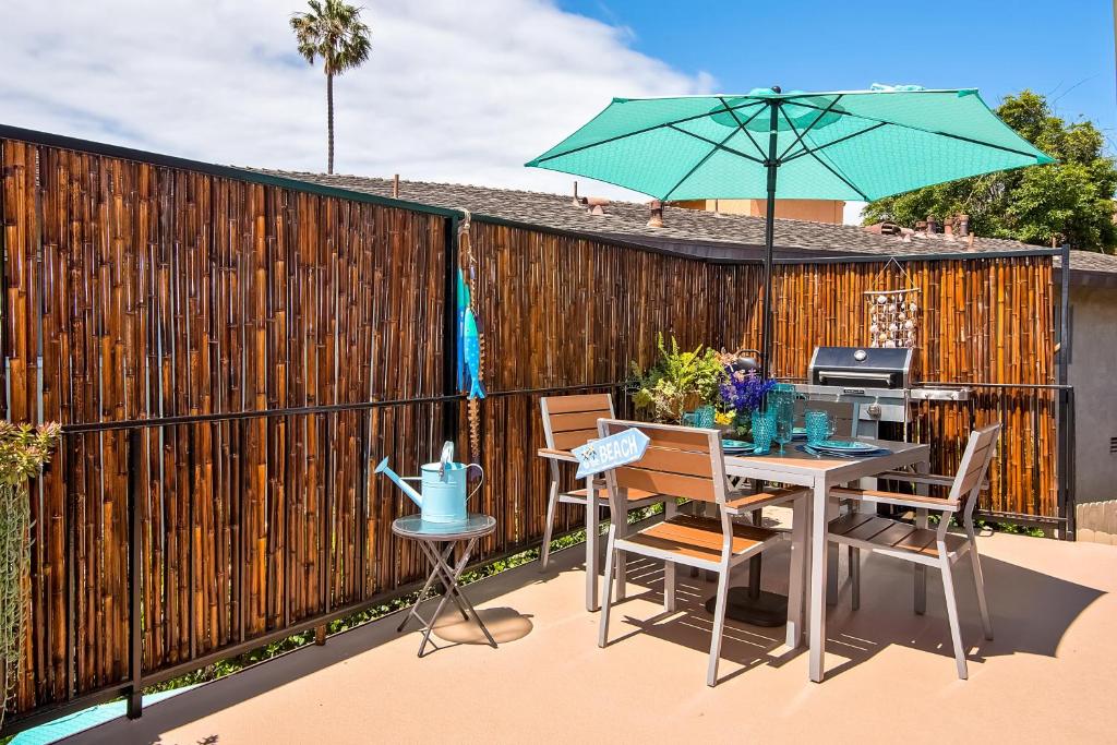 um pátio com uma mesa e um guarda-chuva em Hideaway Unit D em San Clemente
