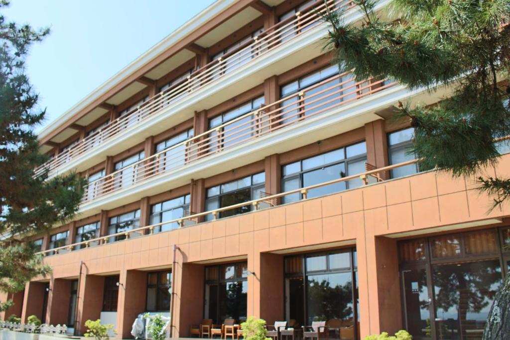 an office building with large windows at Miyajima Seaside Hotel in Miyajima