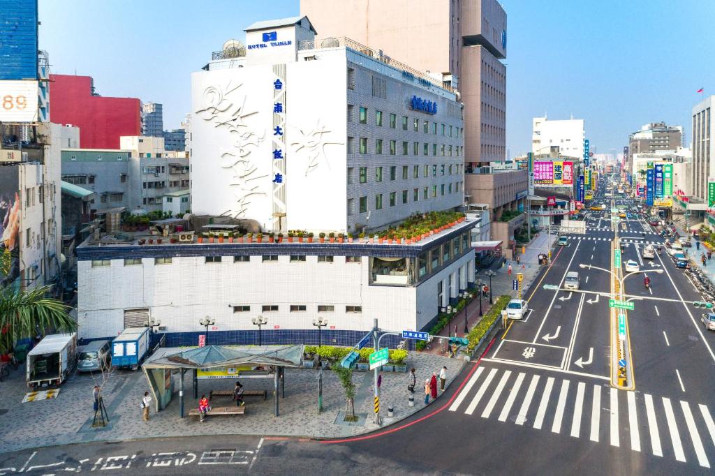 a busy city street with a large white building at Hotel Tainan in Tainan