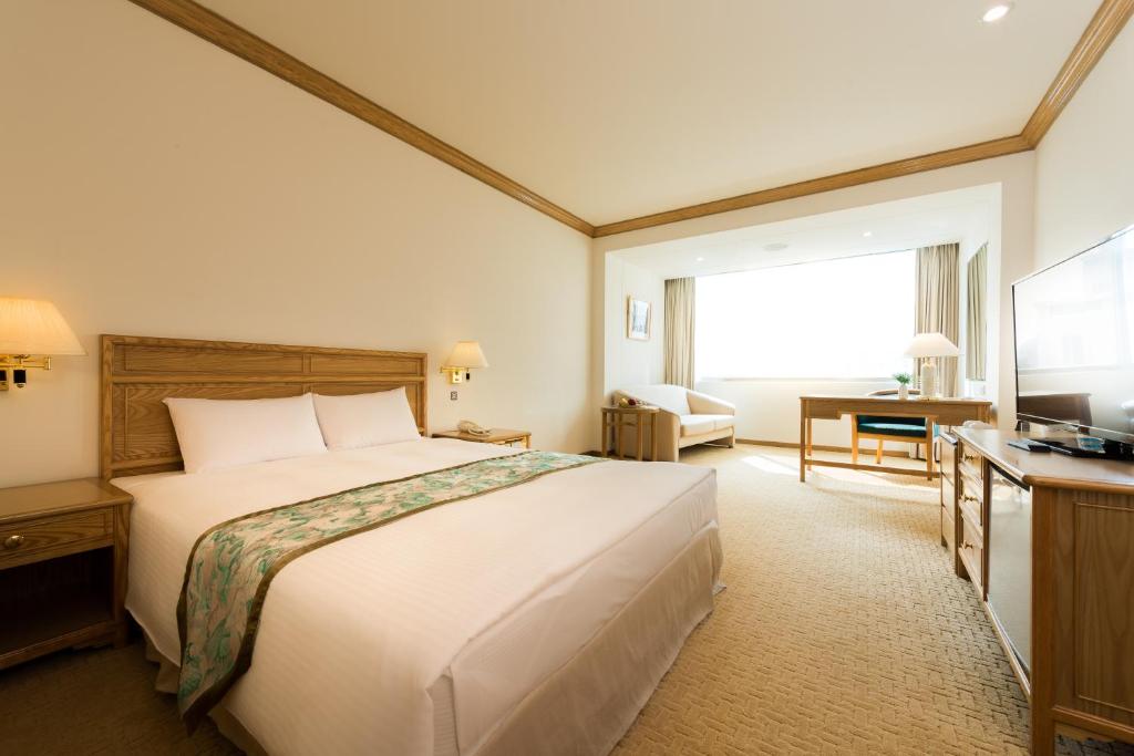 Postel nebo postele na pokoji v ubytování Hotel Tainan