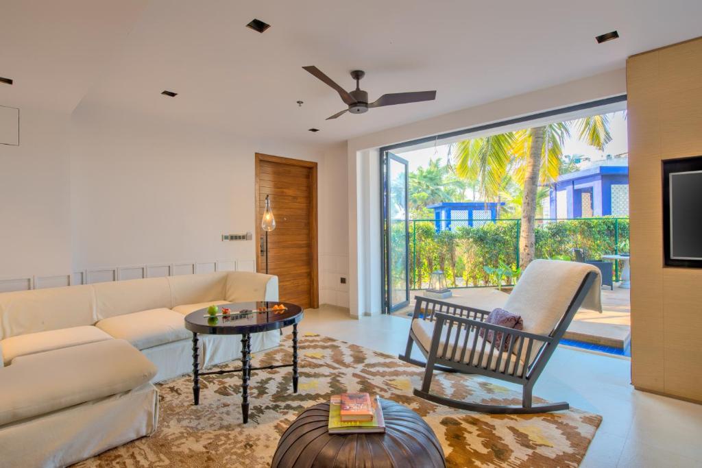 a living room with a couch and a table at Azaya Beach Resort Goa in Benaulim