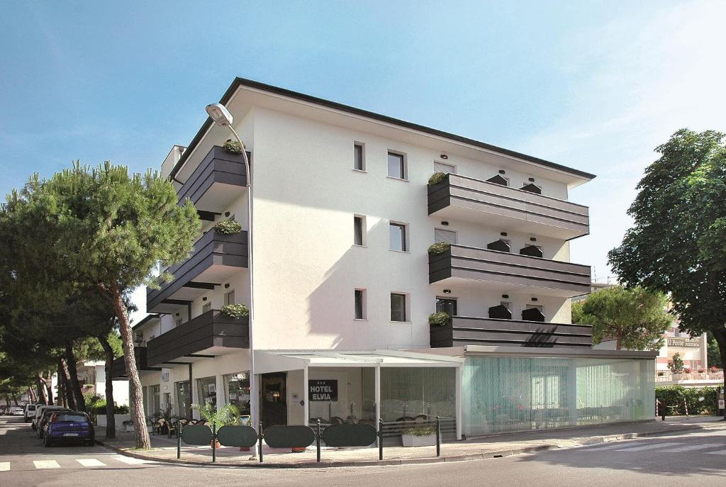 a white building with a lot of windows at Hotel Elvia in Lignano Sabbiadoro