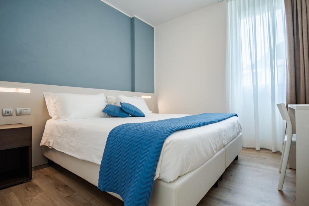 Postel nebo postele na pokoji v ubytování Hotel Vischi
