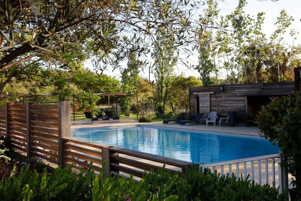 a swimming pool in a yard with a fence at San Giovanni in Porto-Vecchio