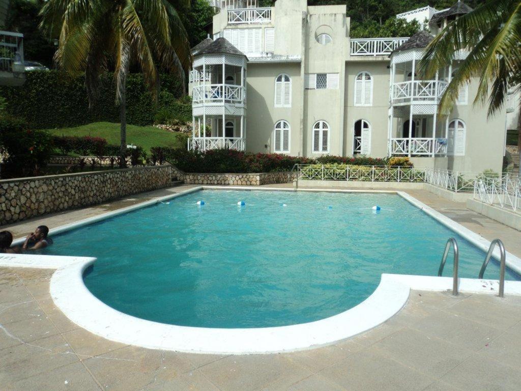 a large swimming pool in front of a building at Chill on the Hill in Ocho Rios