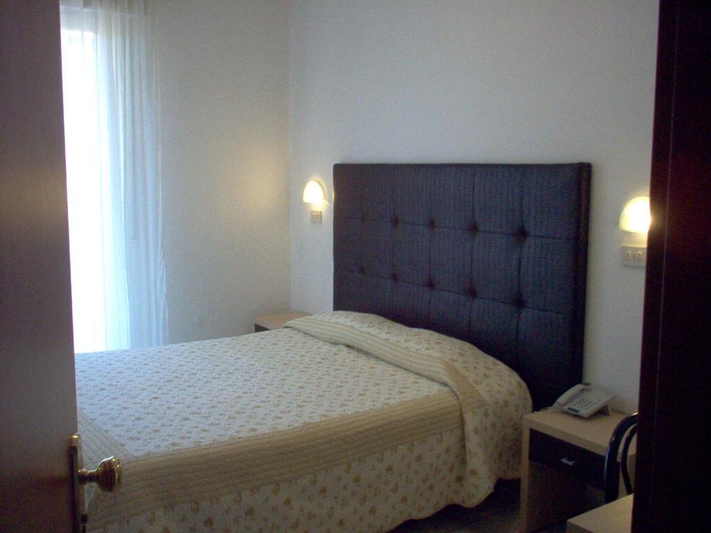 Postel nebo postele na pokoji v ubytování Hotel Universal