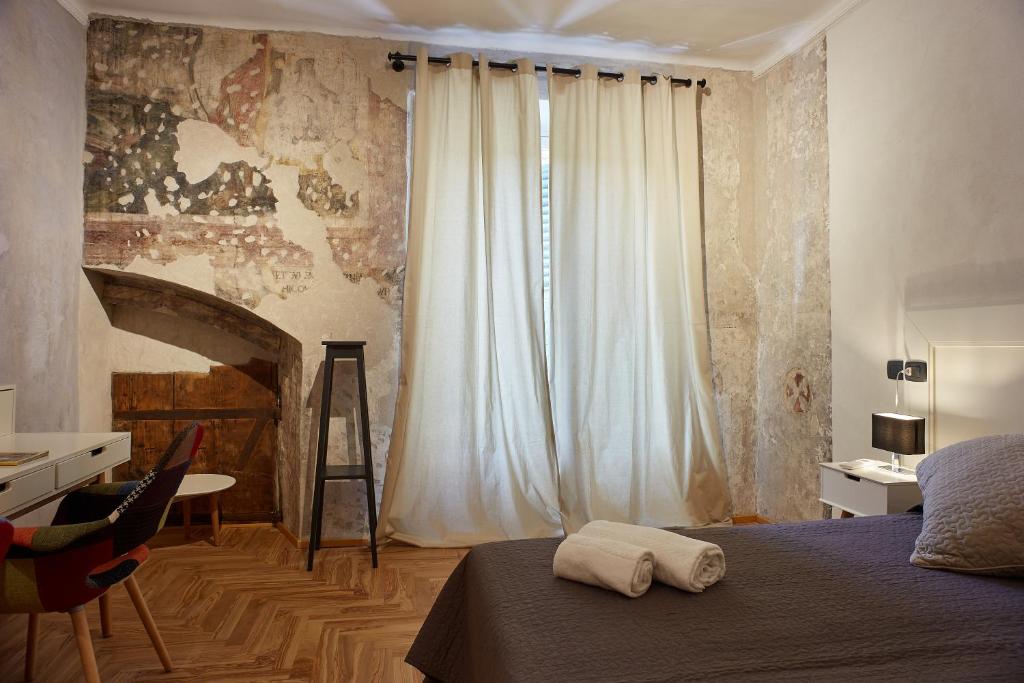 Łóżko lub łóżka w pokoju w obiekcie Casa Spinetta Malaspina - Verona Apartments