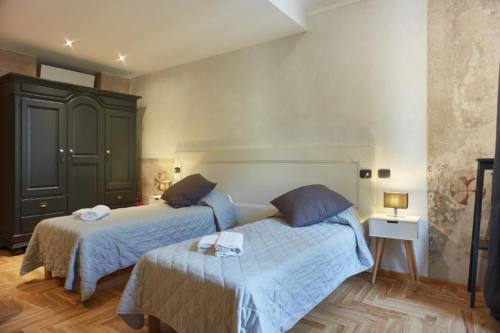 Łóżko lub łóżka w pokoju w obiekcie Casa Spinetta Malaspina - Verona Apartments