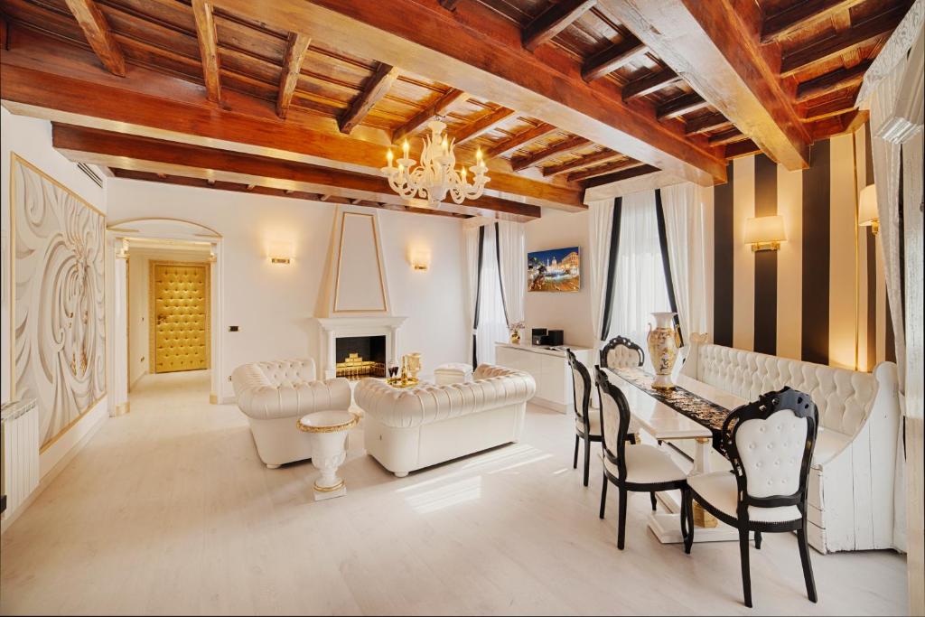 a living room with a table and chairs and a fireplace at Spanish Steps amazing Apartment in Rome