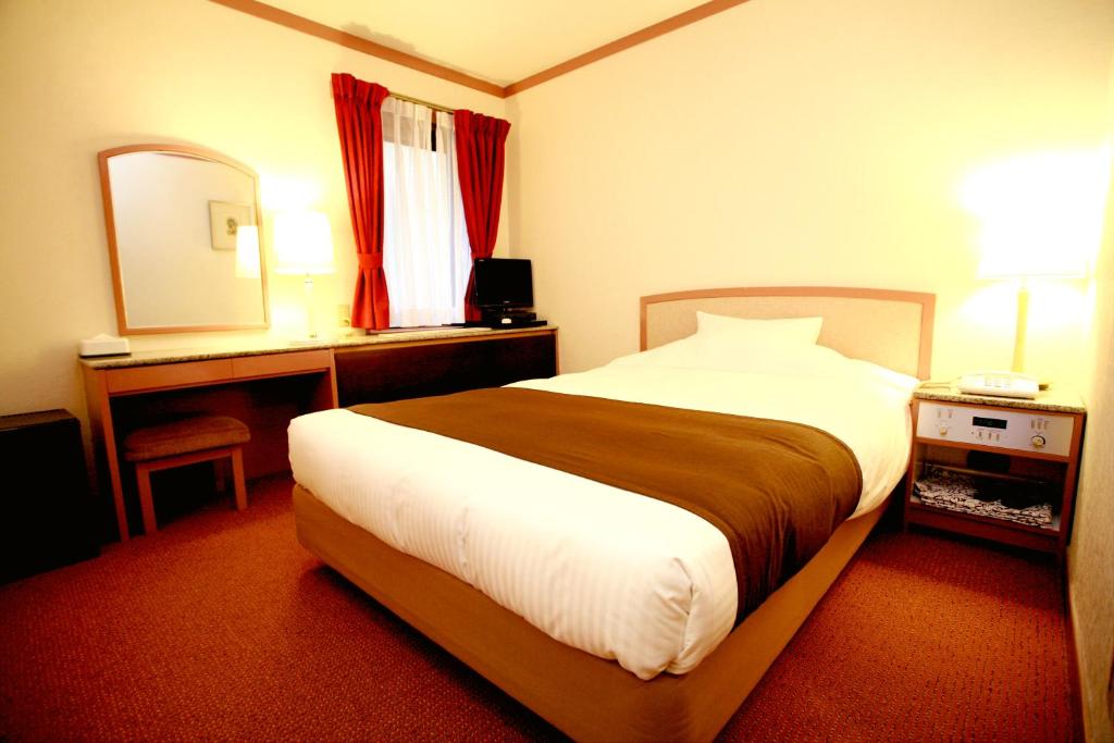 Postel nebo postele na pokoji v ubytování Arrow Hotel in ShinsaiBashi 朝食無料サービス中