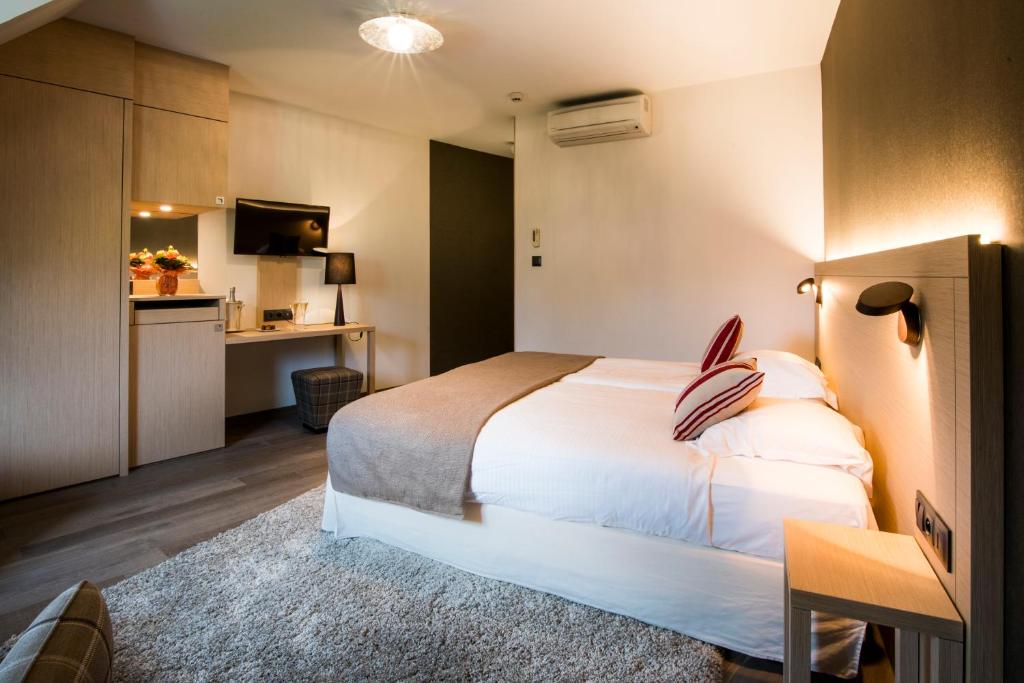 Postel nebo postele na pokoji v ubytování Hotel Restaurant L'Ami Fritz