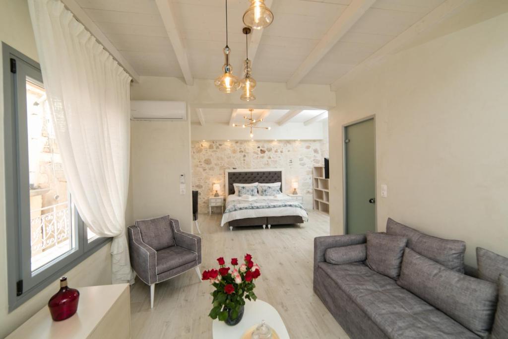 a living room with a couch and a bed at Theodore Suite in Rethymno Town