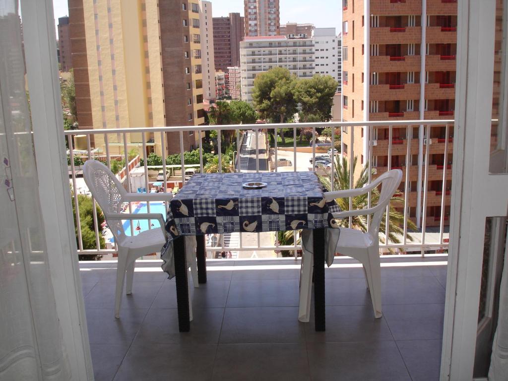 a table and chairs on a balcony with a view of a city at Primavera - Zand Properties in Benidorm