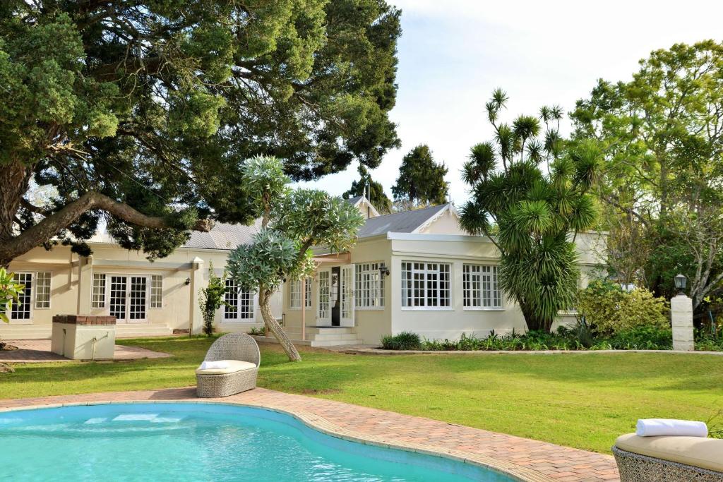 a house with a swimming pool in front of it at Milner Manor in Grahamstown