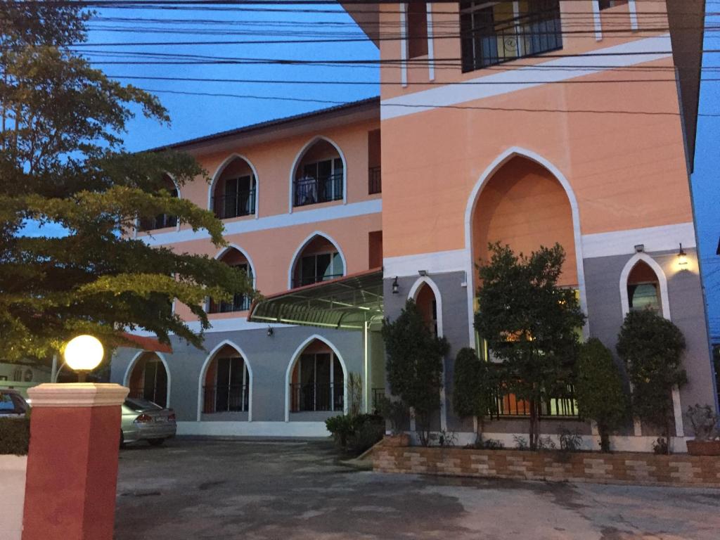 a building with a car parked in front of it at PPS Home in Surin