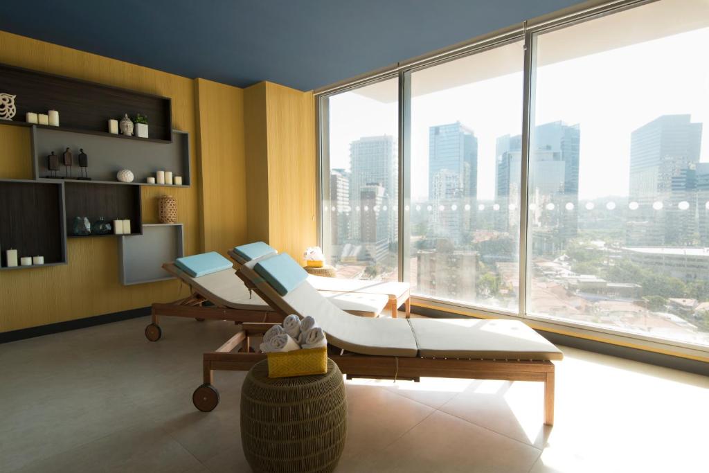 a hospital room with two chairs and a large window at Novotel São Paulo Berrini in Sao Paulo