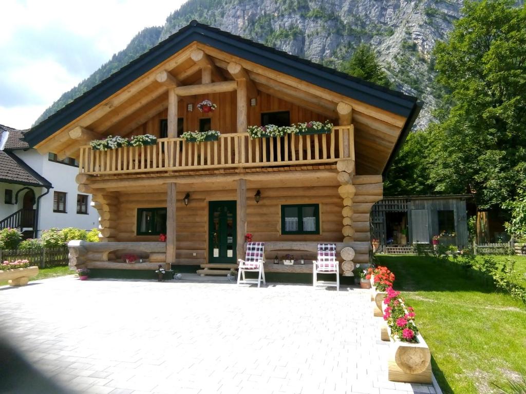 a log cabin with a balcony on top of it at C.T.N. Loghouse in Hallstatt