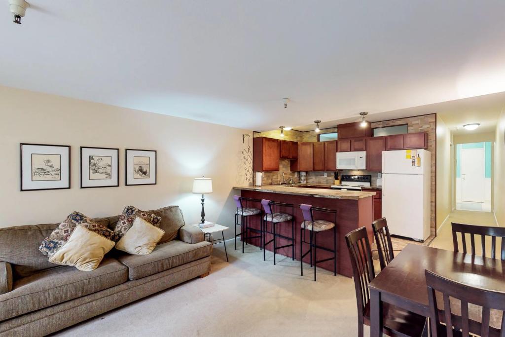 a living room and kitchen with a couch and a table at North #405 in Girdwood